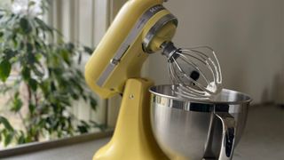 Side profile of the KitchenAid COTY Artisan 4.7L Stand Mixer whipping cream