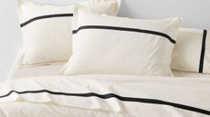 Crate & Barrel's high-contrast, effortlessly elegant Tuxedo Stripe Bedding styled atop of a minimalist bed frame