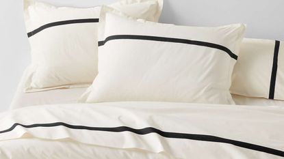 Crate & Barrel's high-contrast, effortlessly elegant Tuxedo Stripe Bedding styled atop of a minimalist bed frame