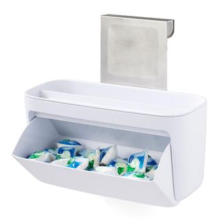 White dishwasher tablet dispenser filled with dishwasher tablets