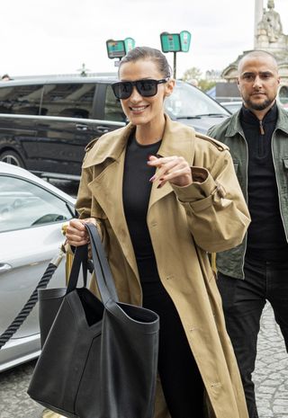 Bella Hadid wearing a trench coat and black bag in Paris