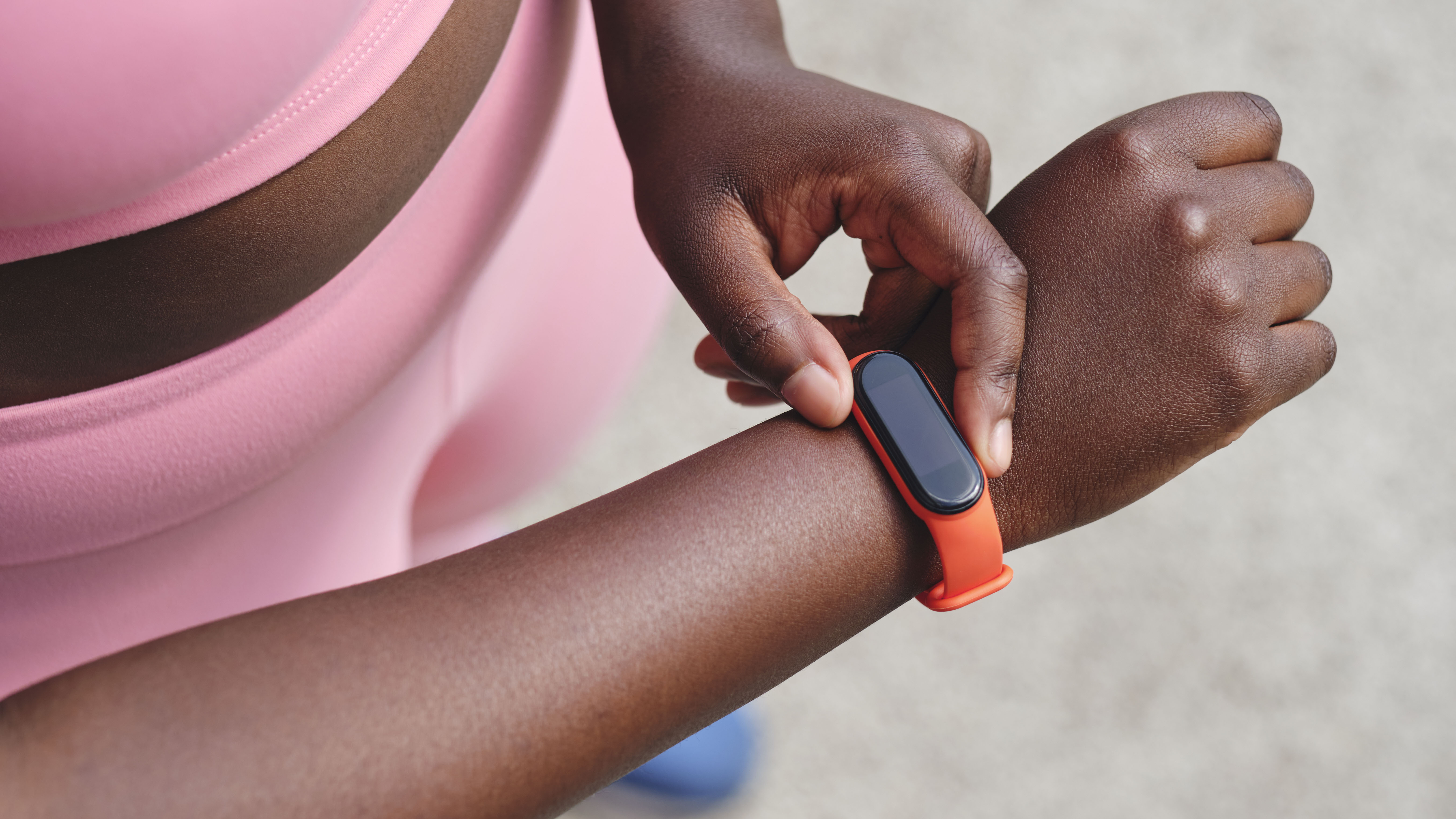 Woman adjusting fitness tracker on wrist