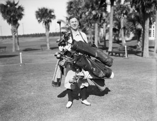 Golfer carrying multiple bags