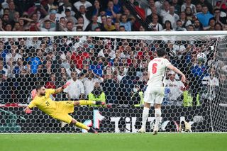Harry Maguire of England scores their team's second penalty in a penalty shoot out past Gianluigi Donnarumma of Italy during the UEFA Euro 2020 Championship Final between Italy and England at Wembley Stadium on July 11, 2021 in London, England.