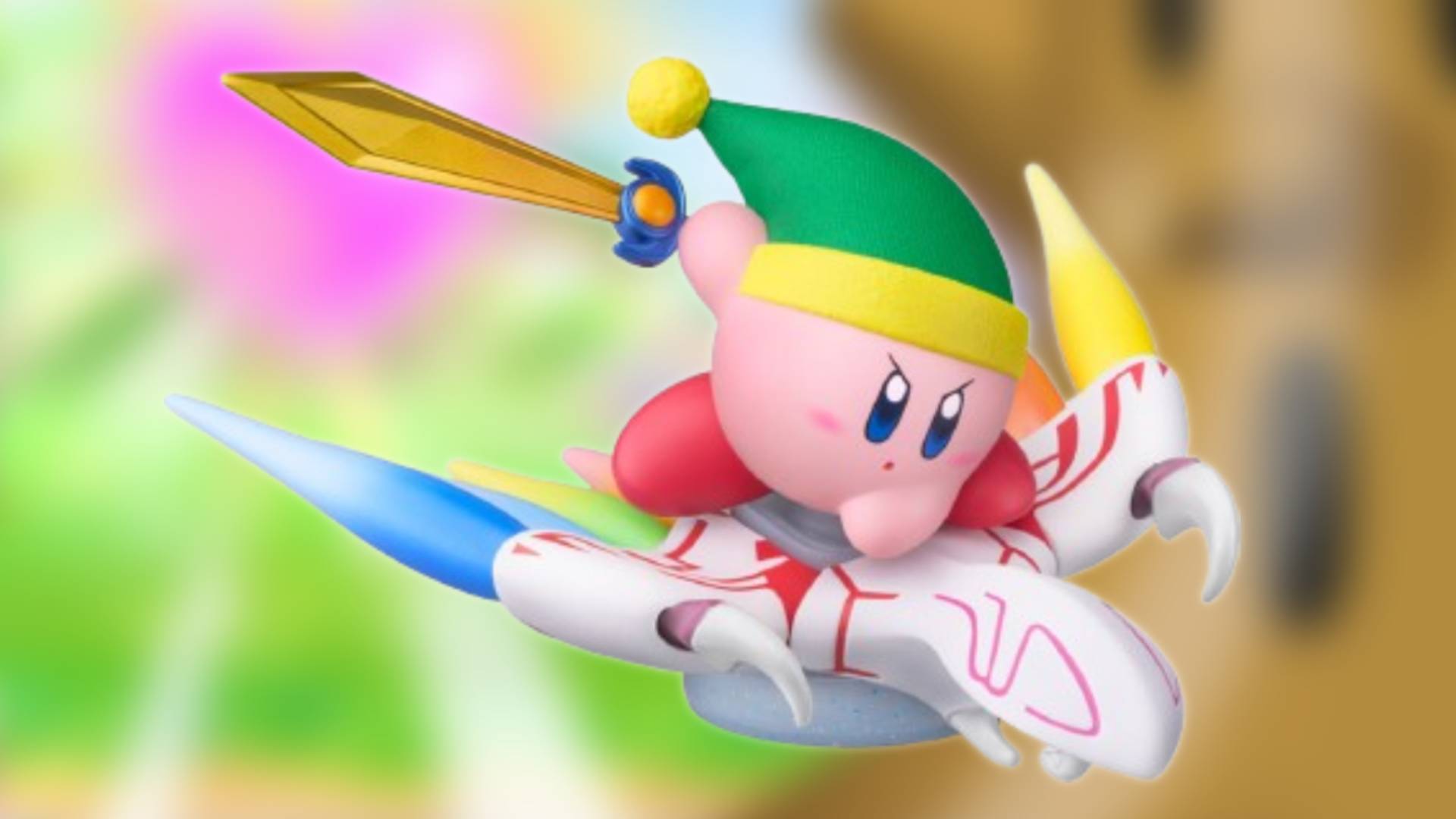 Image of the new Sword Kirby amiibo sitting on a blurred Kirby Air Riders game screenshot.