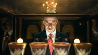 A man stares into a case of expensive glassware in Casi el Paraíso