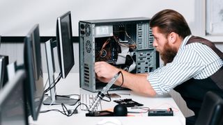 An IT employee repairing a PC