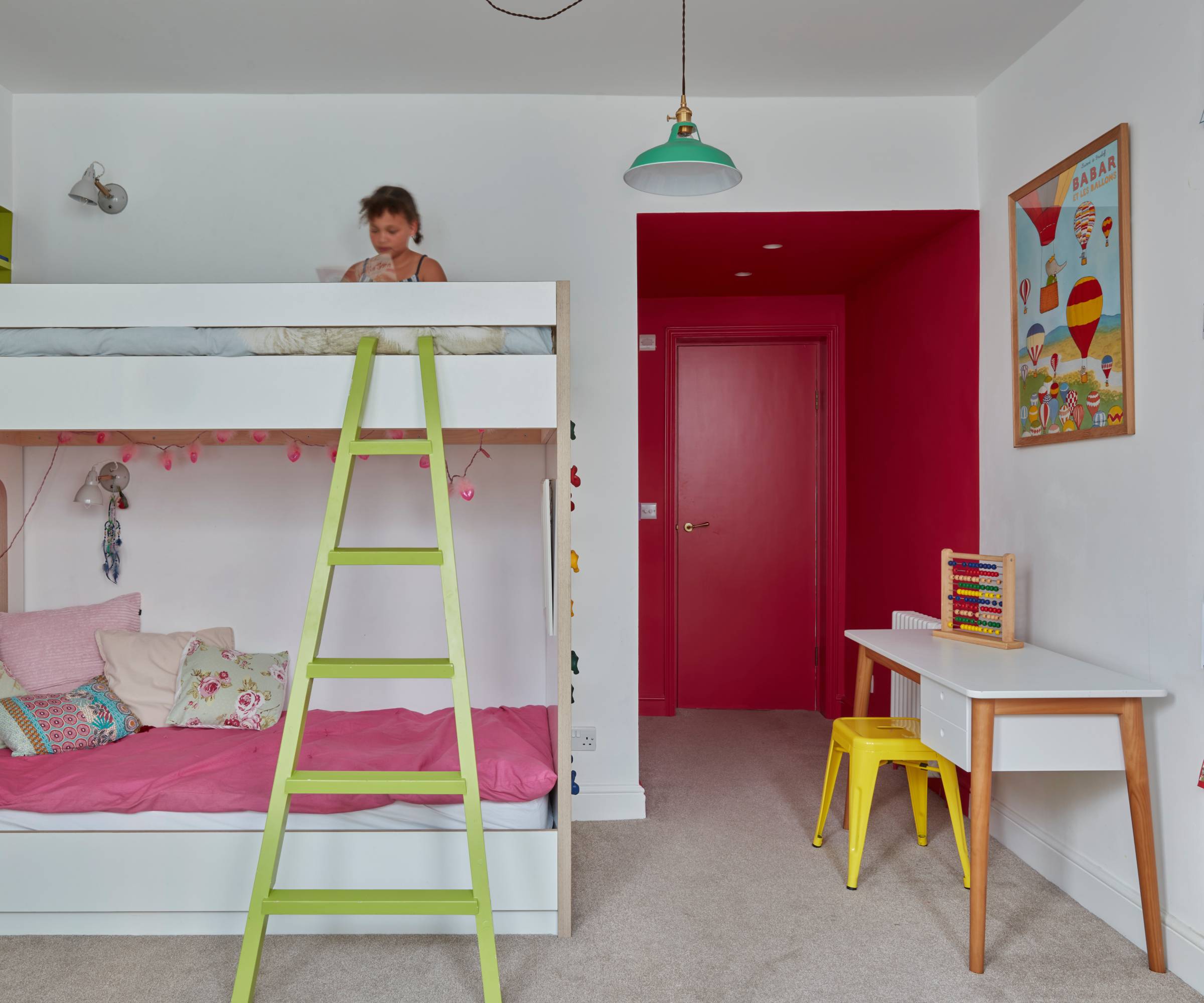child's bedroom with white painted walls and bunk beds, red paint on door and small entrance area into room