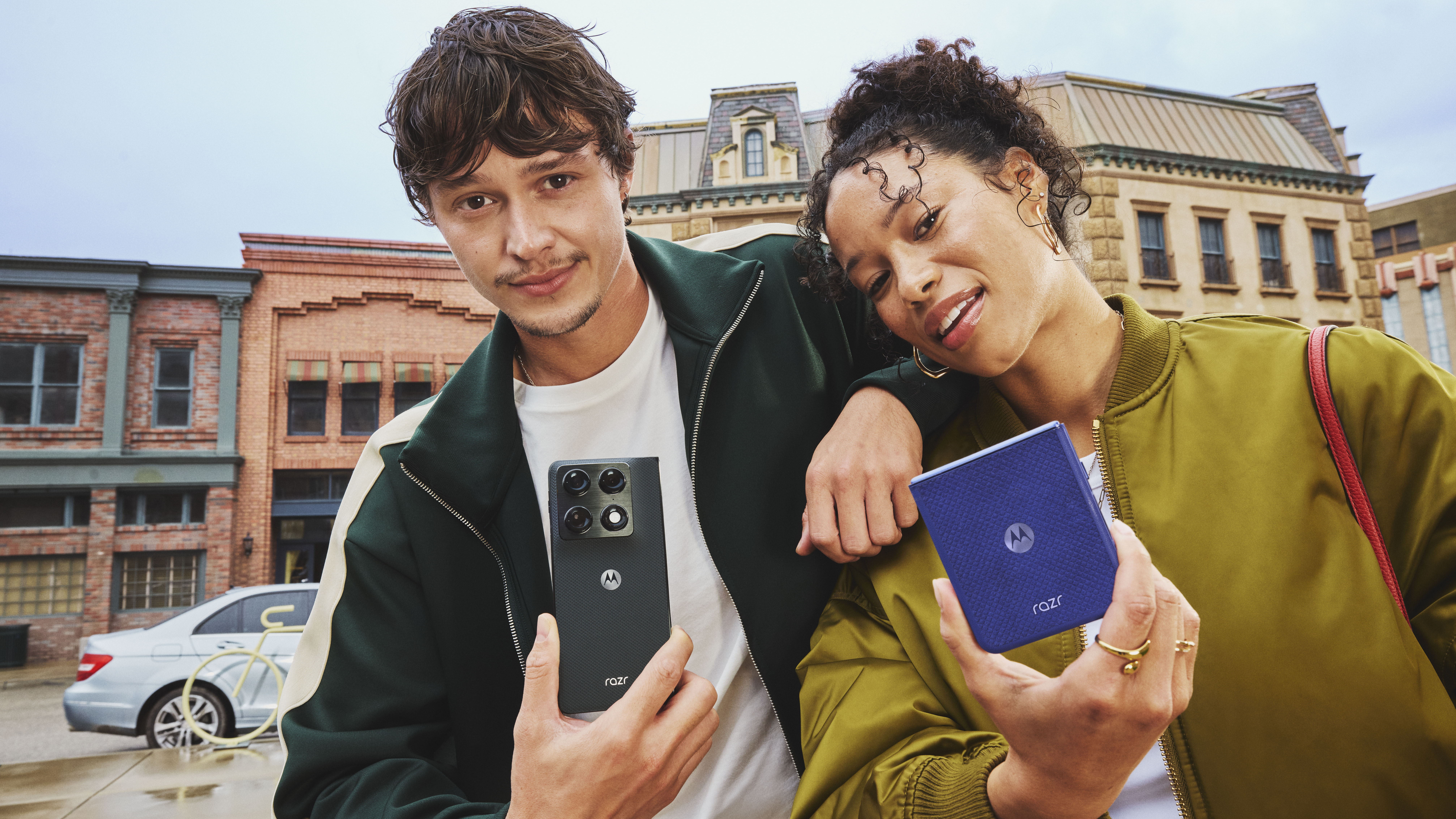 Two people holding the Motorola Razr Fold and the Motorola Razr 70 Ultra