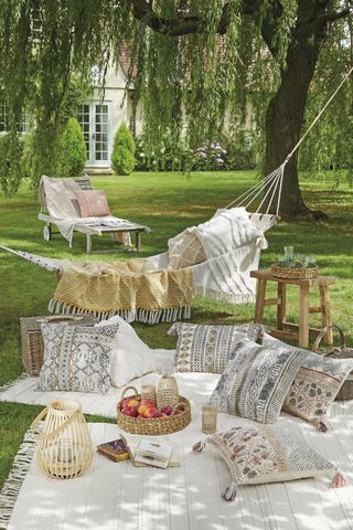 garden with hammock picnic rug and soft furnishings