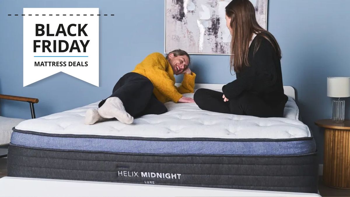 The Image shows two women sitting and laying on the Helix Midnight Luxe mattress