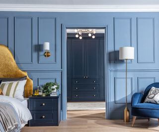 master bedroom with opening through to dressing room, walls and cupboards decorated in different shades of blue