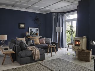 Living room with croft furniture and dark blue walls