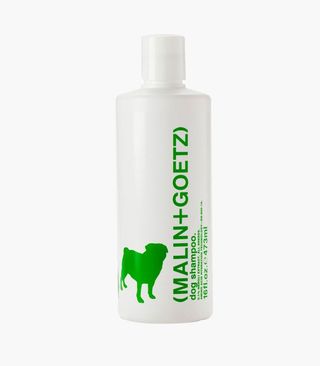 Malin + Goetz dog shampoo in white bottle with green writing against grey background