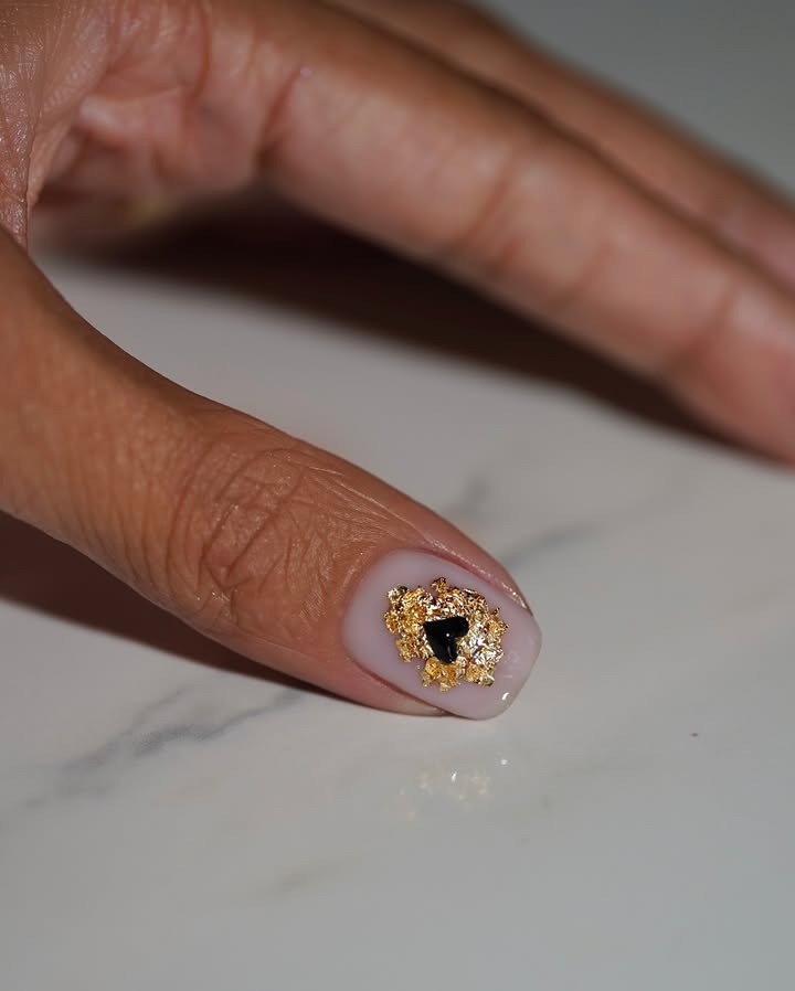 Nude nails with gold foil decals.