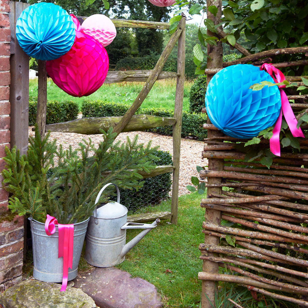 garden area with willow fence and watering can