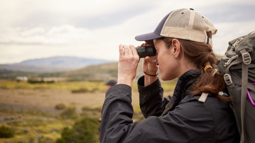 woman using a monocular in the countryside