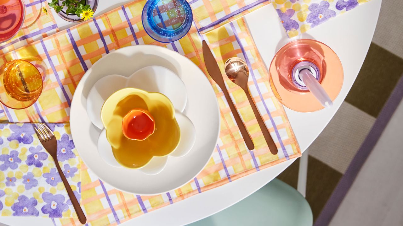 a collection of colorful plates, glasses and table mats