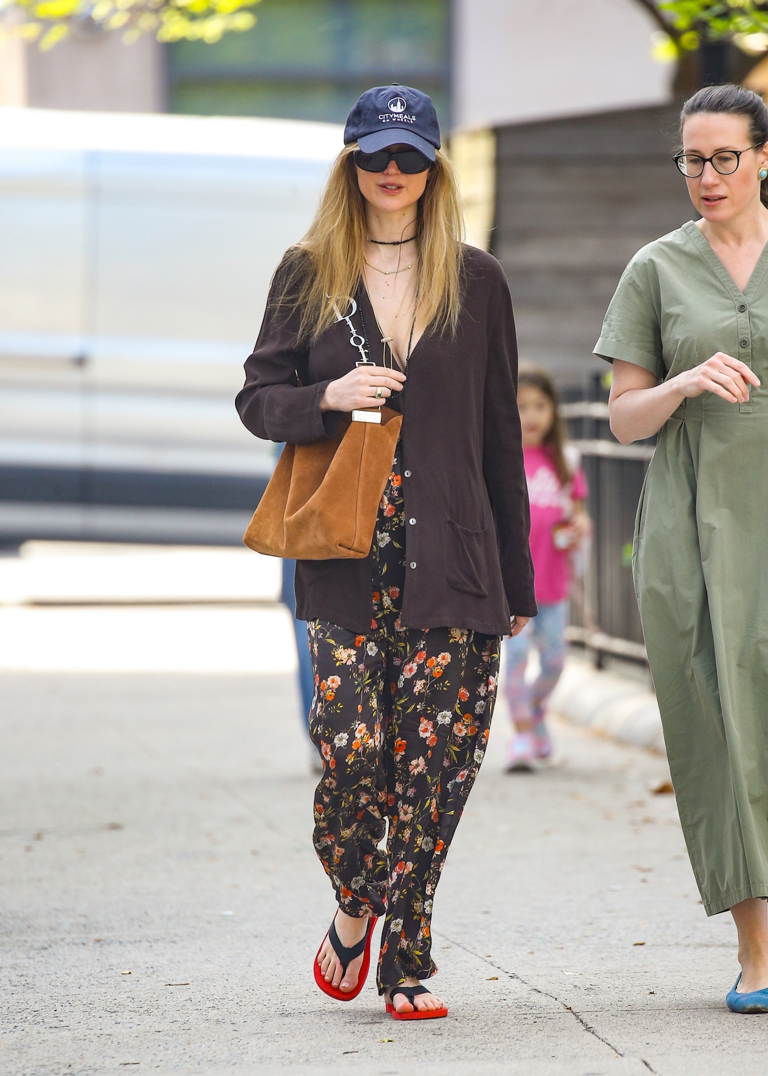 Jennifer Lawrence enjoyed the spring weather in last summer's favorite The Row Dune flip-flops and a monogrammed Dior bag