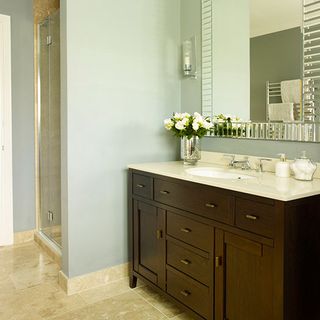 bathroom with tiled flooring and mirror on wall