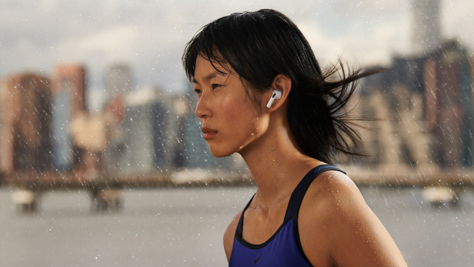 a woman wearing the airpods (third generation) while working out
