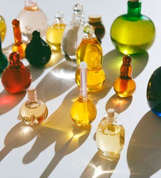 multiple multi-colour handblown glass bottles of skincare products by Kindred Black