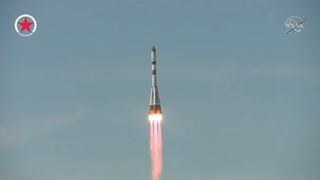 Photo of the Russian Soyuz rocket launching Progress 81 in a clear sky.