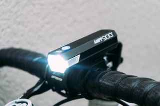 A black bike light switched on to show the beam intensity