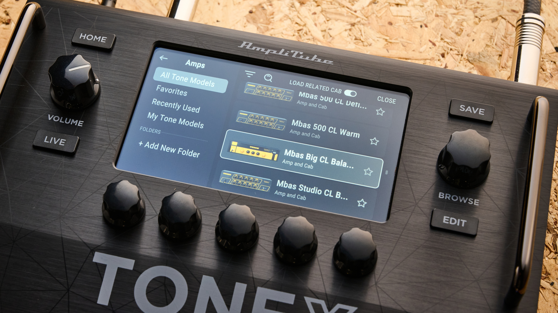 IK Multimedia Tonex Board shot on OSB wood surface.