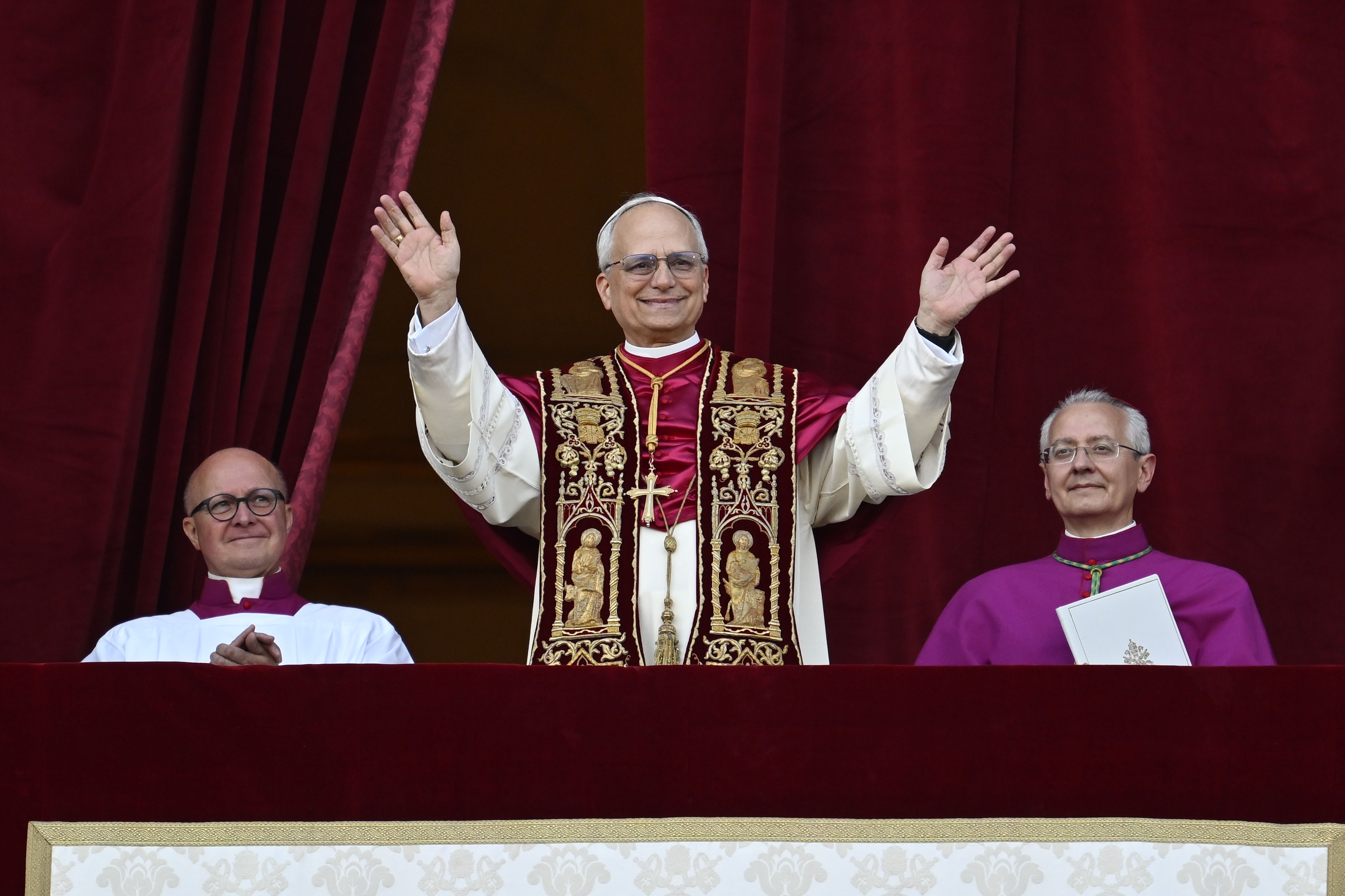 Pope Leo XIV waves at the crowds outside the Vatican