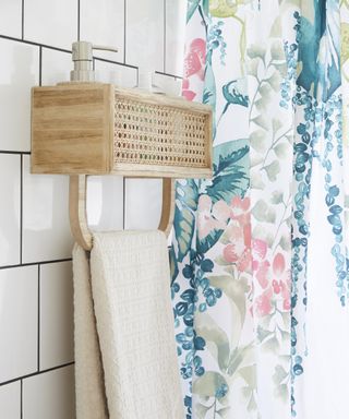 Rattan shower shelf with teal and pink shower curtain by Dunelm