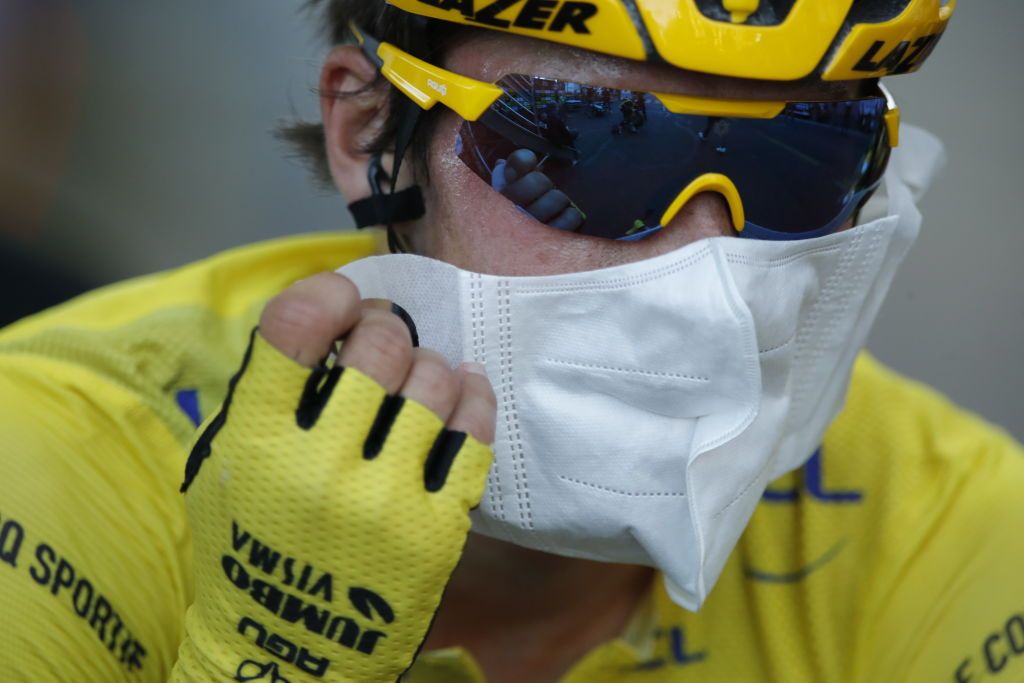 Team Jumbo rider Slovenias Primoz Roglic wearing the overall leaders yellow jersey wears a mask after crossing the finish line during the 14th stage of the 107th edition of the Tour de France cycling race 197 km between ClermontFerrand and Lyon on September 12 2020 Photo by STEPHANE MAHE POOL AFP Photo by STEPHANE MAHEPOOLAFP via Getty Images