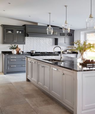Kitchen with dark gray cabinetry and light gray island