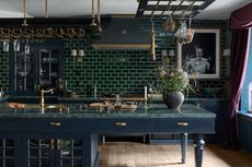 green kitchen wall color with hanging pans and glasses