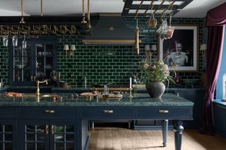 green kitchen with hanging pans and glasses