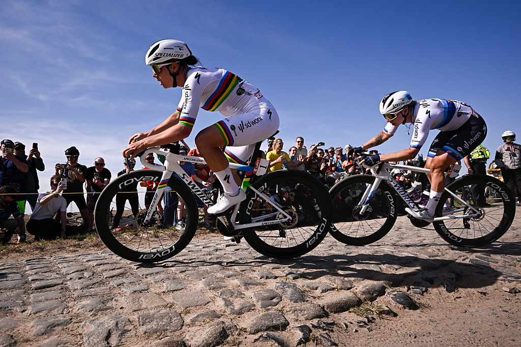 Side shot of Lotte Kopecky leading Lorena Wiebes over a rough cobbled sector during Paris-Roubaix 2025
