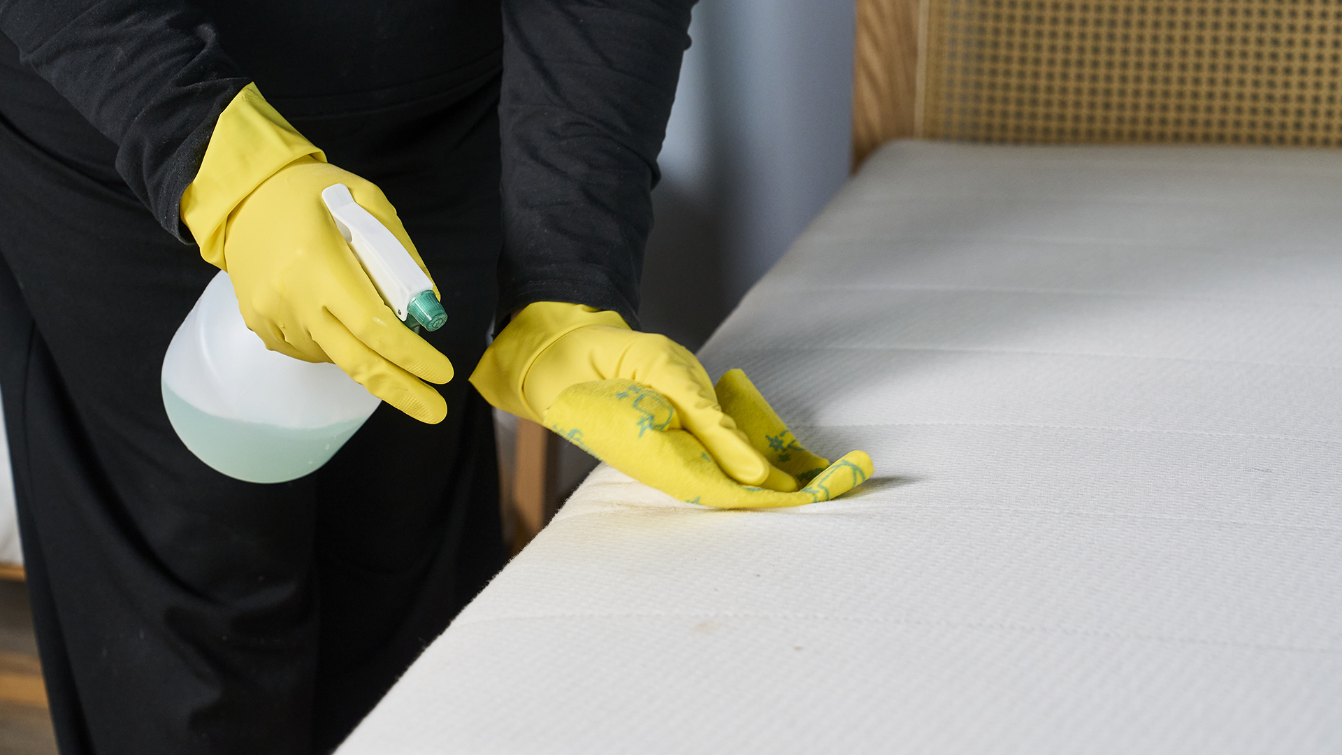 A green mattress cleaning solution in a spray bottle