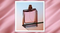 a glass perfume bottle, on a pastel gradient background/ in a template with a silk fabric ripple effect