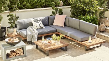 large grey outdoor corner sofa with wooden side tables