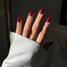 An image of @leatngu showing her cherry red nails