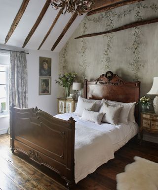 bedroom with beams and original wide plank floorboards