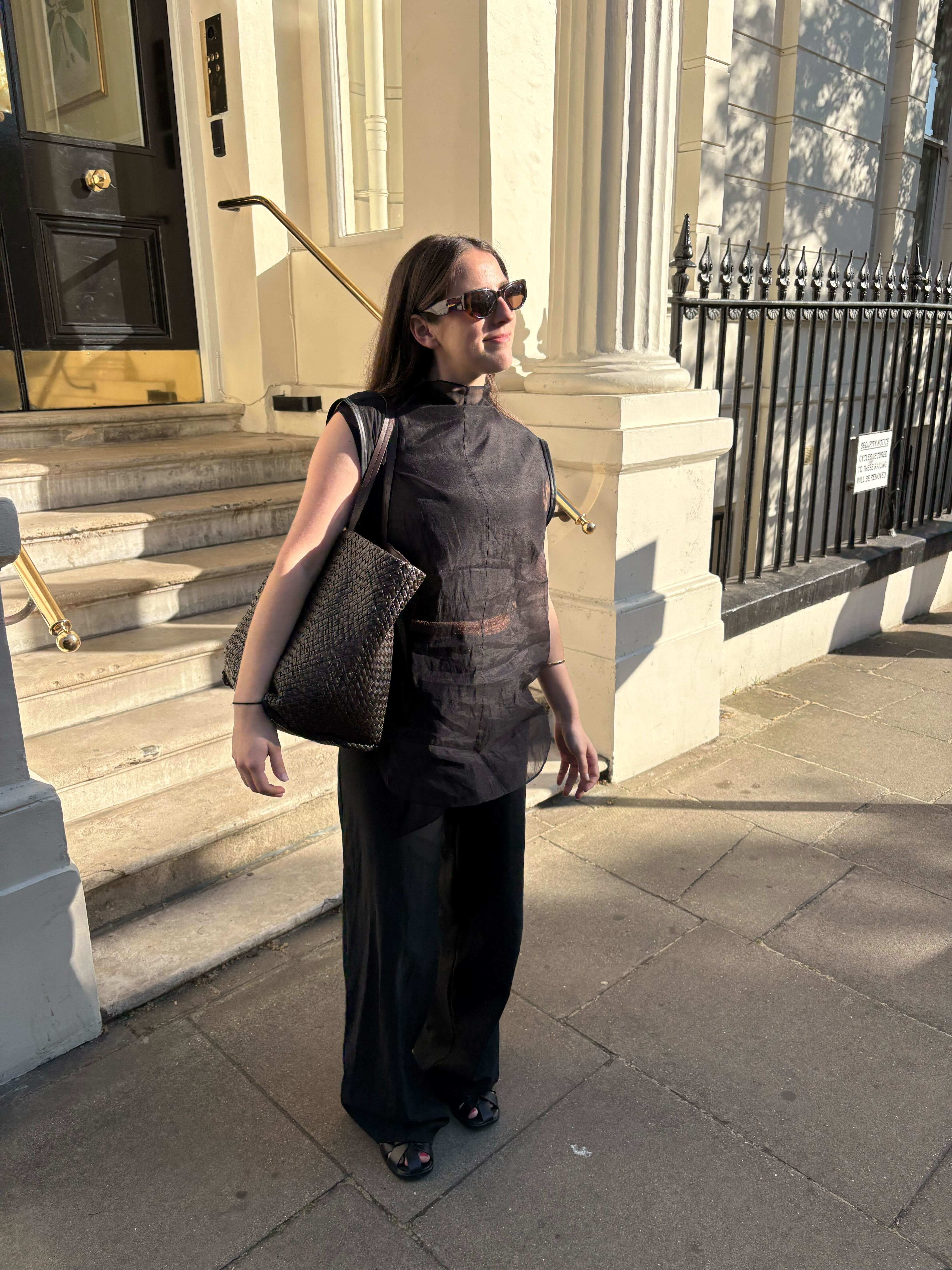 An image of @avahgilchrist wearing a sheer blouse.