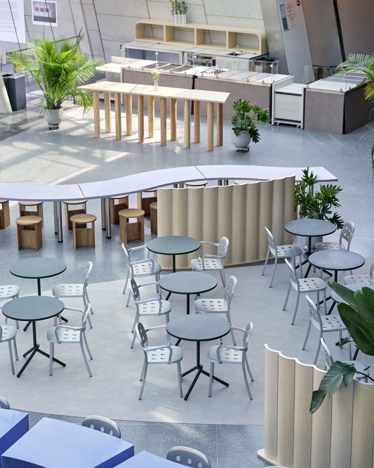 The interiors of the Brooklyn Museum's new cafe feature whimsically shaped and arranged furniture in pastel and metal tones.