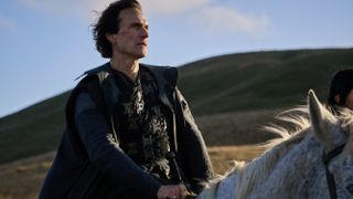 Simon Merrells on horseback as Gundleus in The Winter King cast.