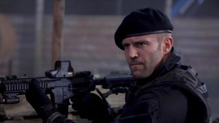 Jason Statham as Lee Christmas holding firearm in The Expendables