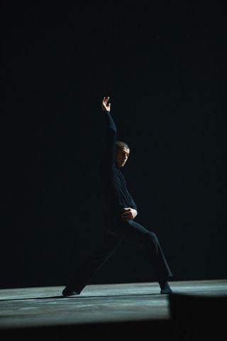 Man wearing black Alaïa outfit dancing