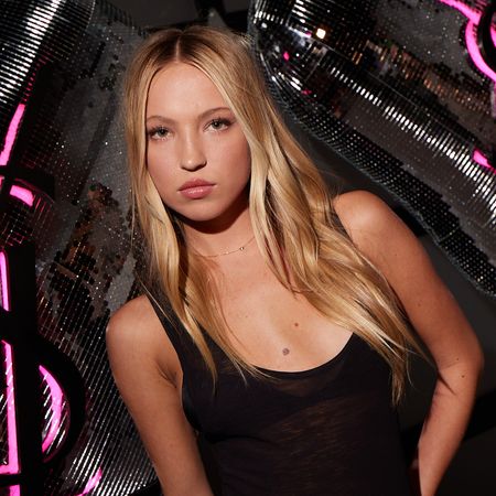Lila Moss in front of a step and repeat for an Yves Saint Laurent beauty event