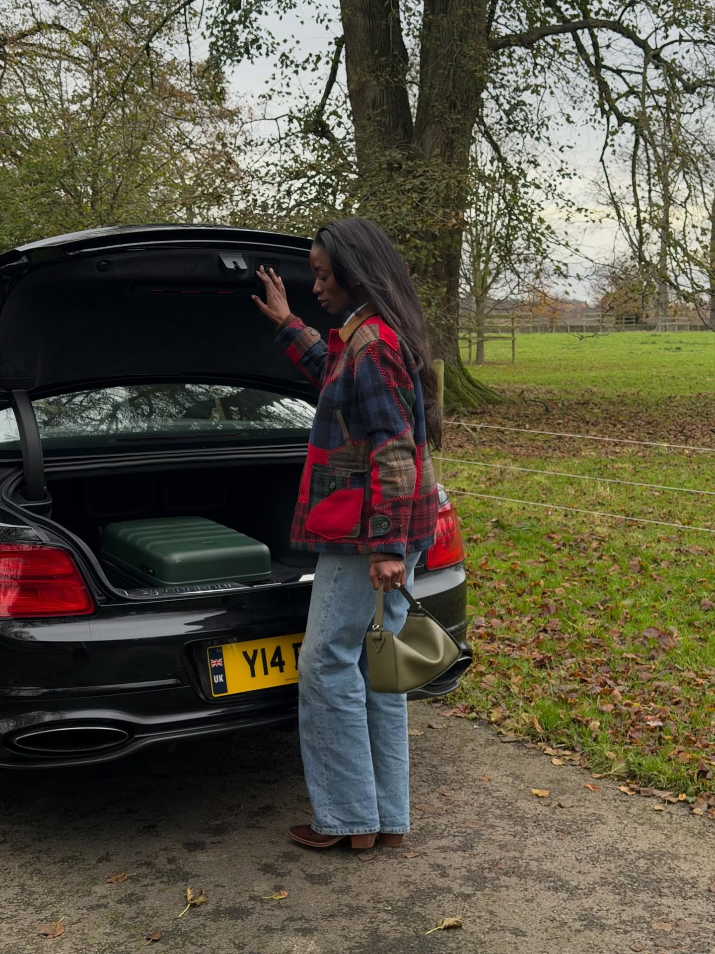 Woman wearing colorful handbag, a 2026 trend.