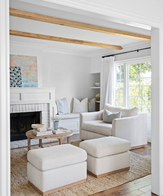 A white armchair in a neutral-toned living room.