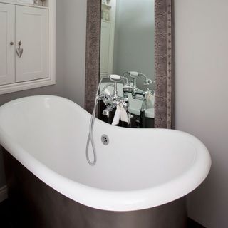 white bathroom with bathtub and mirror